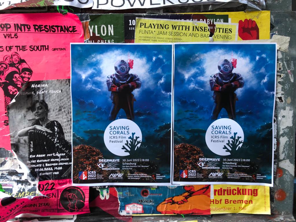 Zwei Plakate des ICRS Filmfestivals hängen vor mehren punten Plakaten